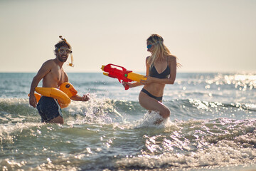 Two friends having a water gun fight