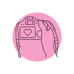 Professional photographer holding camera black line icon.