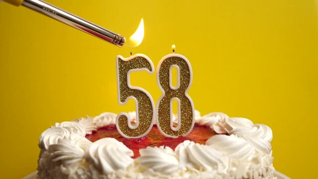 A candle in the form of the number 58 is lit, which is stuck into the holiday cake. Celebrating a birthday or a landmark event. The climax of the celebration.