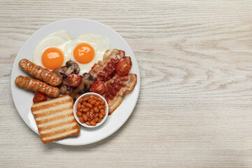 Plate of fried eggs, sausages, mushrooms, beans, bacon and toast on white wooden table, top view with space for text. Traditional English breakfast