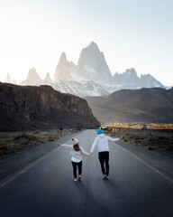 Travelers couple in love enjoying the view of majestic Mount Fitz Roy - symbol of Patagonia, Argentina