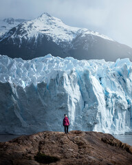 A woman posing on the ice formation of the Perito Moreno glacier, Argentina