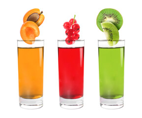 Different freshly made juices on white background. Fruits falling into glasses © New Africa