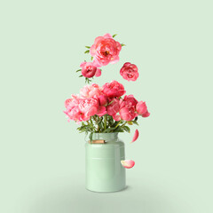 Flower buds flying into bunch of pink peonies on pastel light green background. Beautiful bouquet