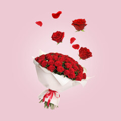 Flower buds and petals flying into bunch of red roses on pink background. Beautiful bouquet