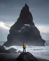 A woman posing on  the black beach of Reynisfjall in Iceland