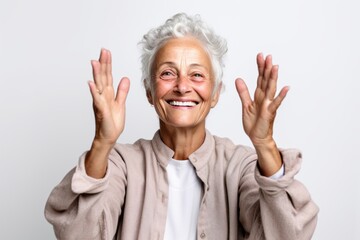 Medium shot portrait photography of a grinning mature woman joining palms in a gesture of gratitude against a white background. With generative AI technology