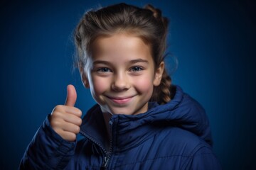 Headshot portrait photography of a tender kid female showing a thumb up against a deep indigo background. With generative AI technology