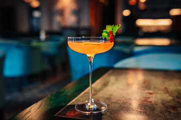 alcoholic cocktail in a glass stands on a table in a bar or restaurant