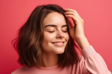 Close-up portrait photography of a grinning girl in her 20s holding the hand on the forehead in a headache gesture against a hot pink background. With generative AI technology