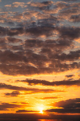 Fototapeta na wymiar Glowing Horizon: Sun-kissed Clouds at Dusk or dawn