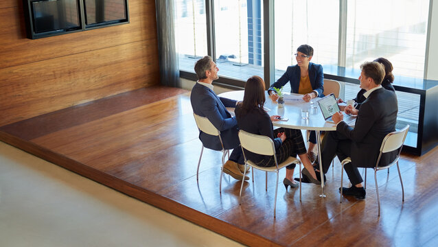 Professional, Group And Meeting For A Discussion Or Collaboration At A Company With A Plan. Teamwork, Conversation And Strategy At A Table For A Project Or Partnership With Tech At The Office.