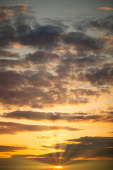 Fototapeta na wymiar Glowing Horizon: Sun-kissed Clouds at Dusk or dawn