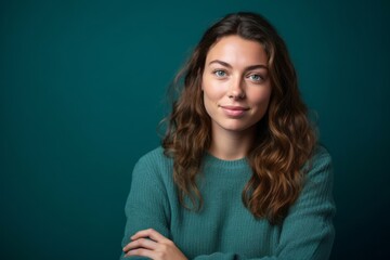 Fototapeta premium Medium shot portrait photography of a satisfied girl in her 30s crossing the arms against a teal blue background. With generative AI technology