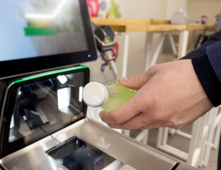 Customer pays his purchase at the supermarket,self checkout systems in  retail stores,Barcode scanner,Self checkout machine