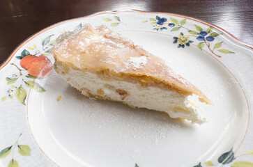 a piece of cake on a plate, on the restaurant table