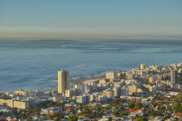 Cityscape, urban buildings and architecture by ocean, infrastructure and property development in metro. Skyline, cbd and seaside with city skyscraper, Cape Town and mockup space in summer sunshine