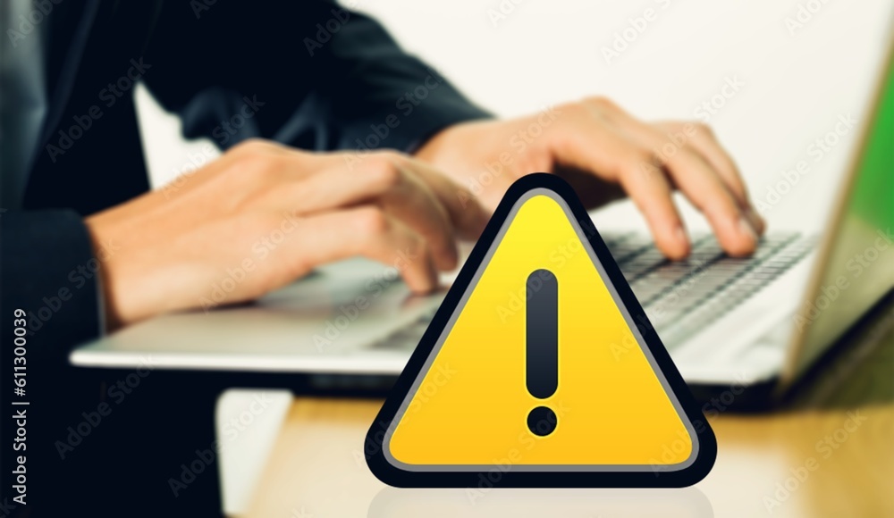 Poster warning yellow sign on table with computer