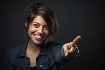 Close-up portrait photography of a grinning girl in her 30s raising a finger as if having an idea...