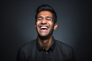 Obraz premium Headshot portrait photography of a happy boy in his 30s covering one eye against a metallic silver background. With generative AI technology