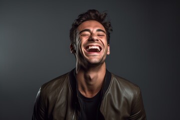 Fototapeta premium Medium shot portrait photography of a satisfied boy in his 30s laughing against a cool gray background. With generative AI technology
