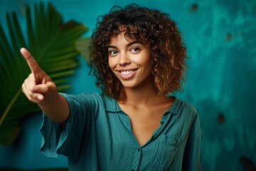 Medium shot portrait photography of a satisfied girl in her 30s pointing at oneself with the index finger against a tropical teal background. With generative AI technology
