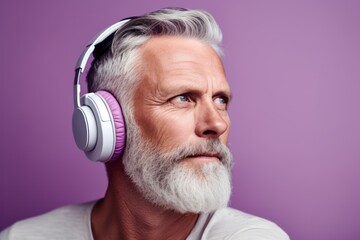 Close-up portrait photography of a glad mature man listening to music with headphones against a lilac purple background. With generative AI technology