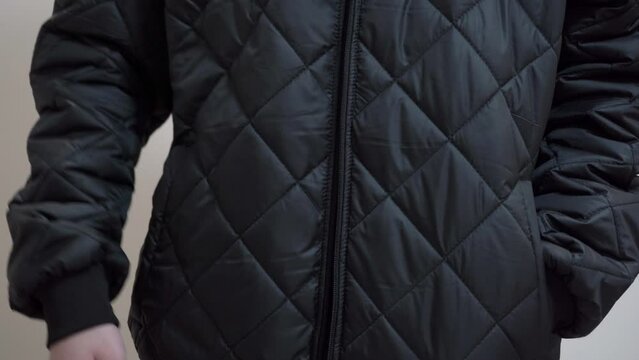 Unzipping A Zipper on a Black Jacket,guy unbuttoning a black jacket, undressing in the room