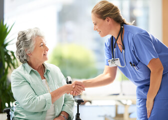 Obraz premium Handshake, nurse and elderly woman in wheelchair with medical results and surgery success news. Hospital, healthcare and clinic with women and nursing staff with care and support of senior person