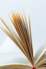 Open old book with text on white background. The concept of reading literature, education and book publishing. Free space for text