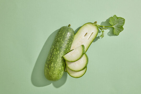 Minimal scene with fresh winter melon placed on pastel background. Winter melon (Benincasa hispida) is low in calories and are ideal for people aiming for weight loss and those with diabetes