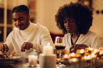 African american couple having romantic dinner date at home