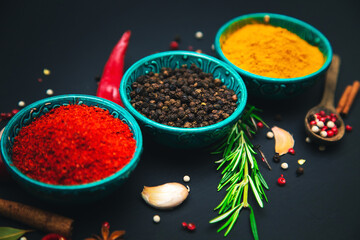 Spices and seasonings for cooking on a dark background.