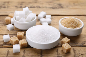 Different types of sugar on wooden table