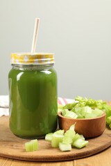 Celery juice in mason jar and fresh vegetable on table