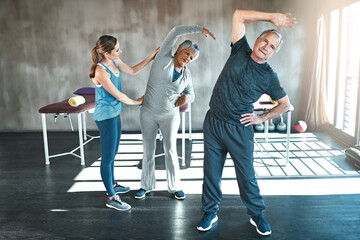 Stretching, physiotherapy and old couple with personal trainer for fitness, wellness and helping....