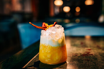 alcoholic cocktail in a glass stands on a table in a bar or restaurant