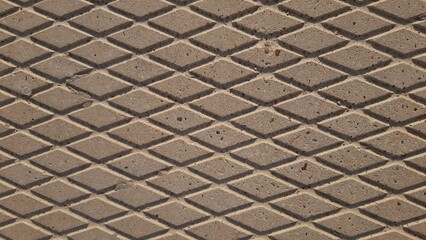 Background, concrete pavement texture, diagonal patterns. Rhombuses, lines. Concrete, tiles, macro. Grey colour