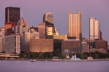 Cityscape of Pittsburgh, Pennsylvania. Allegheny and Monongahela Rivers in Background. Ohio River. Pittsburgh Downtown With Skyscrapers and Beautiful Sunset Sky. Ferry in Roreground - obrazy, fototapety, plakaty