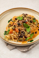 Portion of gourmet pasta spaghetti with kalamata olives