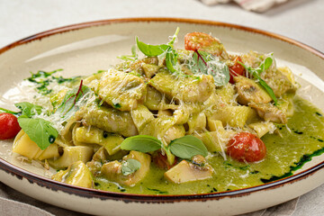 Portion of gourmet pasta fettuccine with pesto sauce