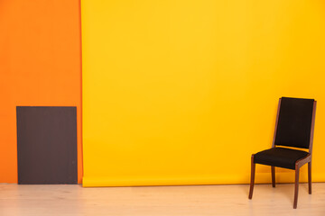 black chair on a yellow background interior in the room