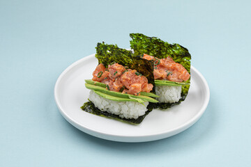 Portion of japanese hand rolls with salmon and avocado