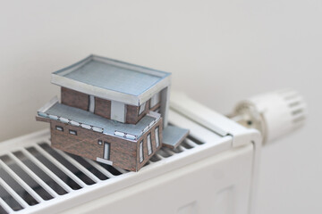 Model of house on white radiator.