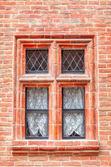 Fototapeta na wymiar Window at red brick wall
