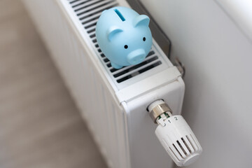 Piggy bank on modern heating radiator