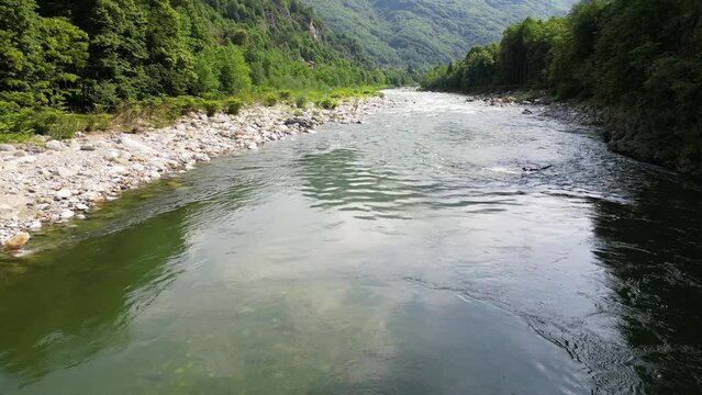 Drone flight over a wooden Tibetan suspended bridge that joins the river banks - view from the drone in Alagna Val Sesia Piedmont Alps mountains - travel concept journey in adventure natural trip 