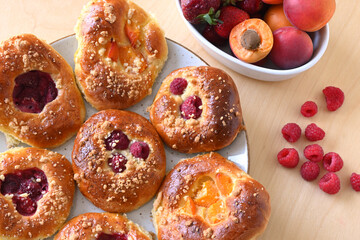 Homemade yeast rolls with fresh fruit: raspberries, strawberries, apricots