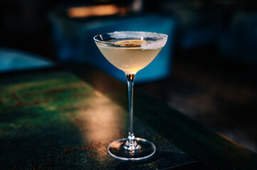 alcoholic cocktail in a glass stands on a table in a bar or restaurant
