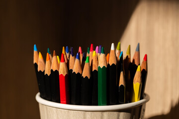 closeup macro shot of color pencils in a cup